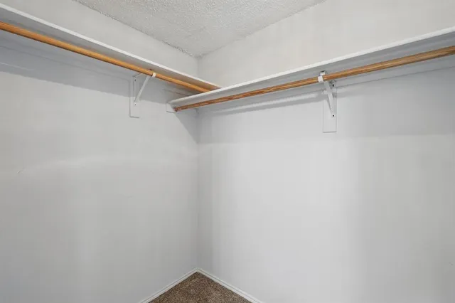 a view of a sink a mirror and cabinets in a room