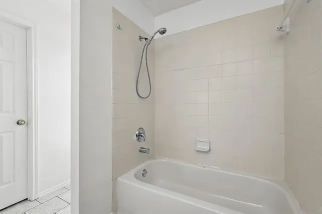 a bathroom with a toilet a sink a mirror and a bathtub