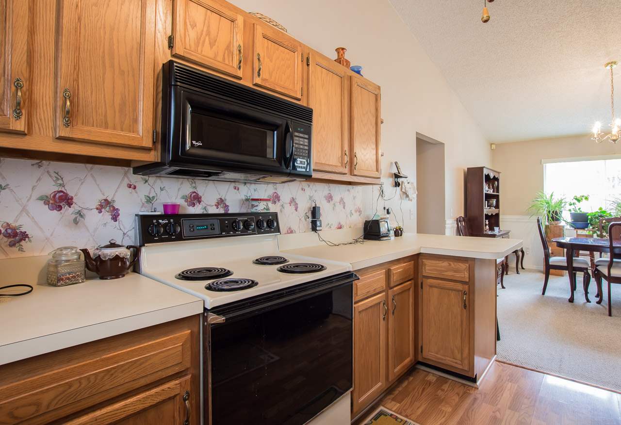 174 Segovia Road St. Augustine, FL 32086 - Photo 11 of 40 a kitchen with stainless steel appliances granite countertop a sink dishwasher a stove and a microwave oven with cabinets