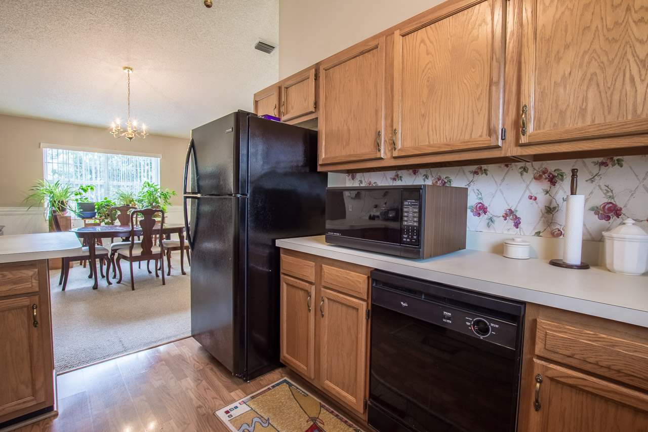 174 Segovia Road St. Augustine, FL 32086 - Photo 12 of 40 a kitchen with stainless steel appliances granite countertop a refrigerator a stove a sink and chairs