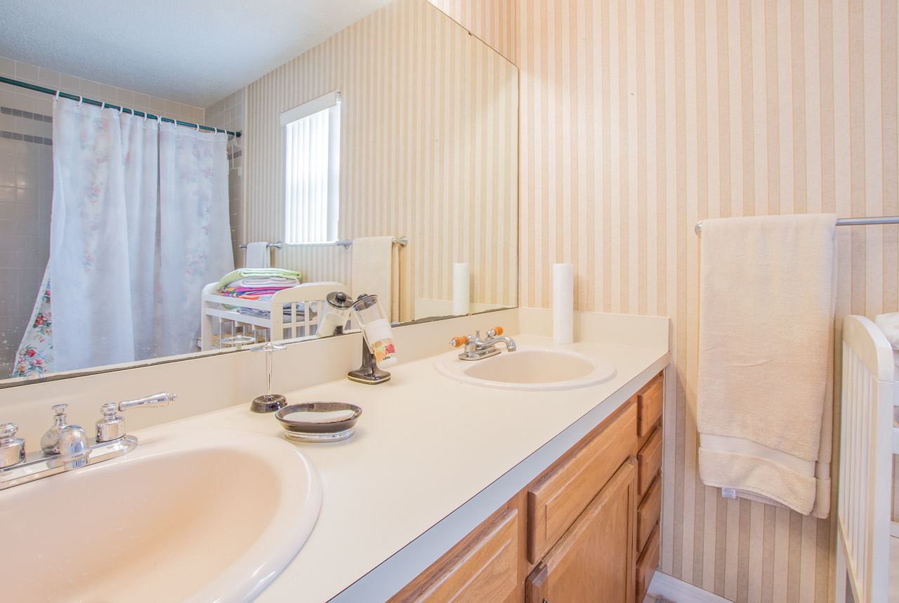 174 Segovia Road St. Augustine, FL 32086 - Photo 15 of 40 a bathroom with a double vanity sink and a mirror