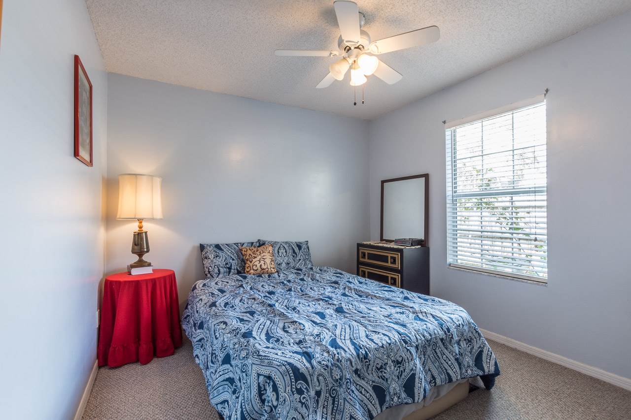 174 Segovia Road St. Augustine, FL 32086 - Photo 21 of 40 a bedroom with a large bed and a chandelier