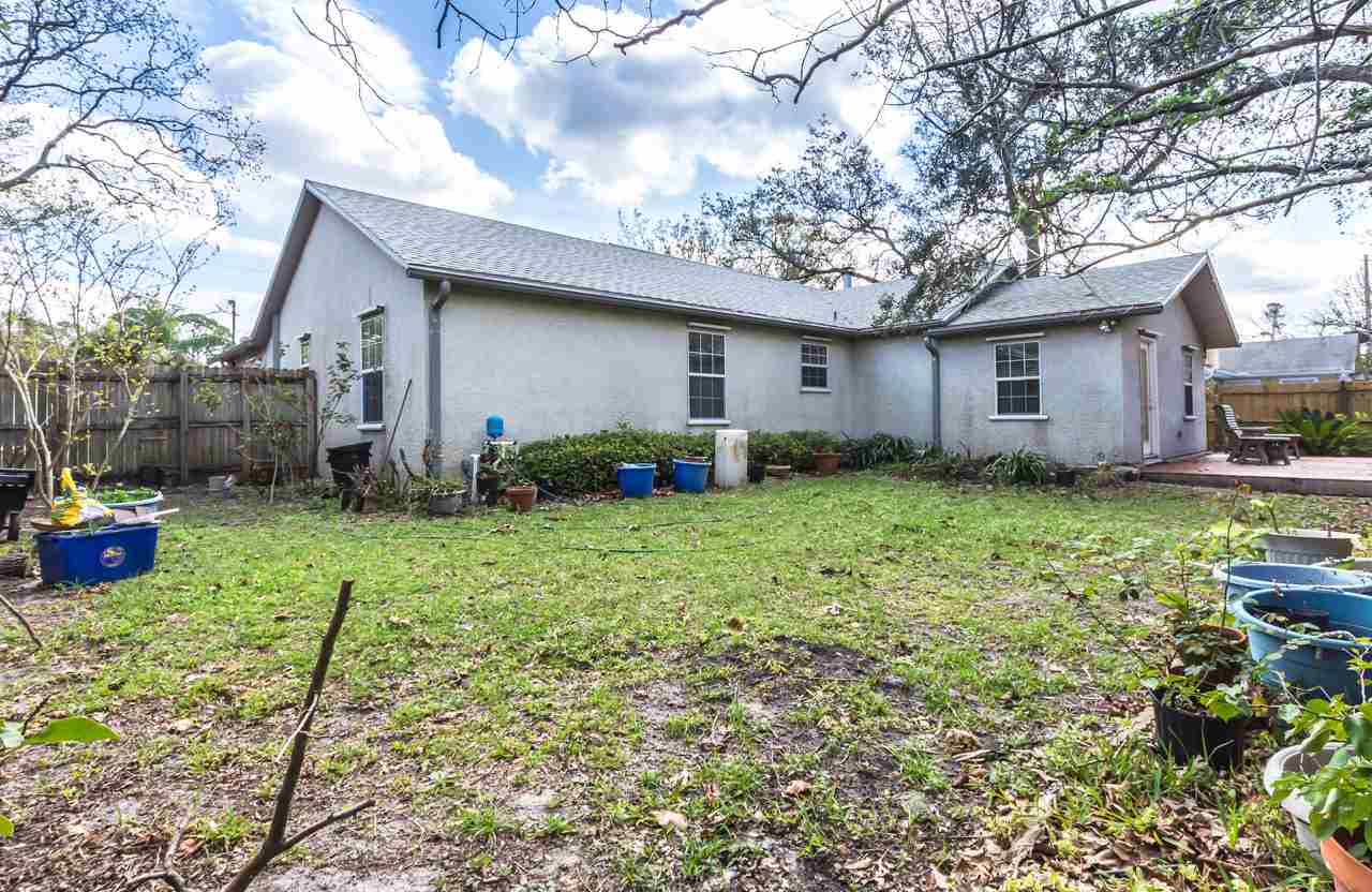 174 Segovia Road St. Augustine, FL 32086 - Photo 23 of 40 a backyard of a house with table and chairs plants