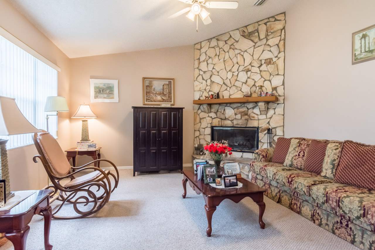 174 Segovia Road St. Augustine, FL 32086 - Photo 10 of 40 a living room with furniture a fireplace and a table