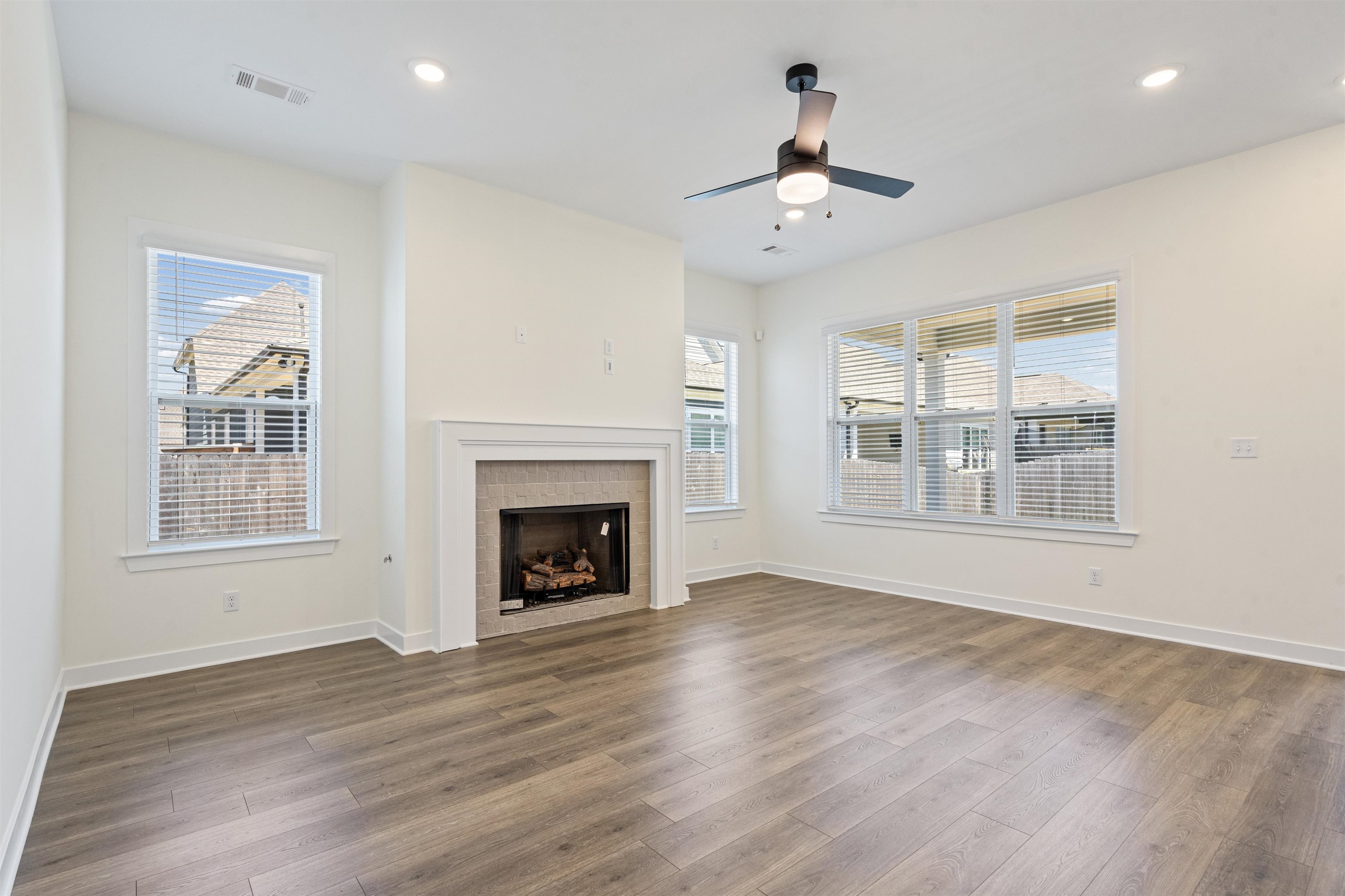 5666 Pleasant Pk Place Arlington, TN 38002 - Photo 11 of 27 Living area featuring a fireplace with a light-colored tile surround and white mantel