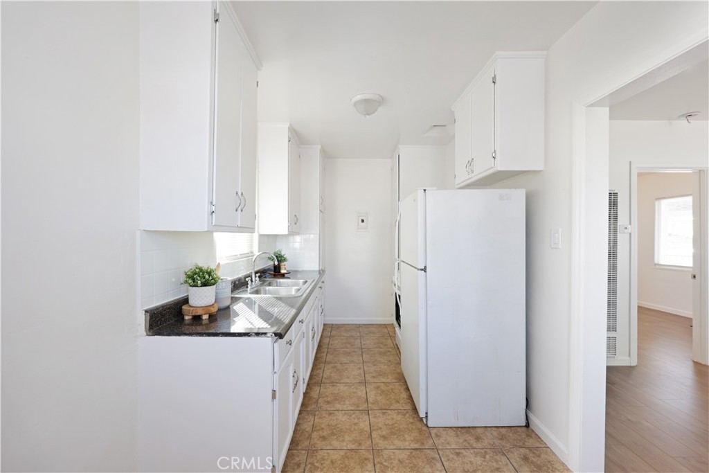 2770 Marengo Street Los Angeles, CA 90033 - Photo 5 of 9 a kitchen with white cabinets and stainless steel appliances