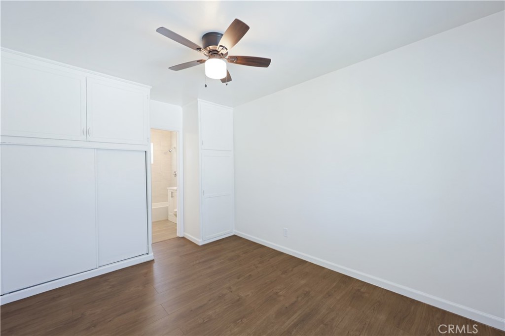 2770 Marengo Street Los Angeles, CA 90033 - Photo 7 of 9 an empty room with wooden floor and a ceiling fan