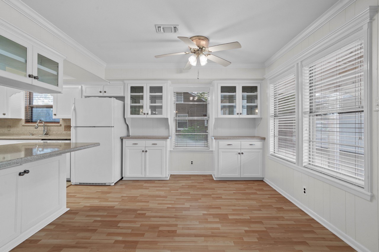702 3rd Street Humble, TX 77338 - Photo 19 of 44 Dining area to the kitchen. Refrigerator will convey. So much storage and natural light shining through.
