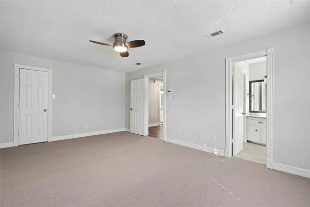 a view of empty room with ceiling fan