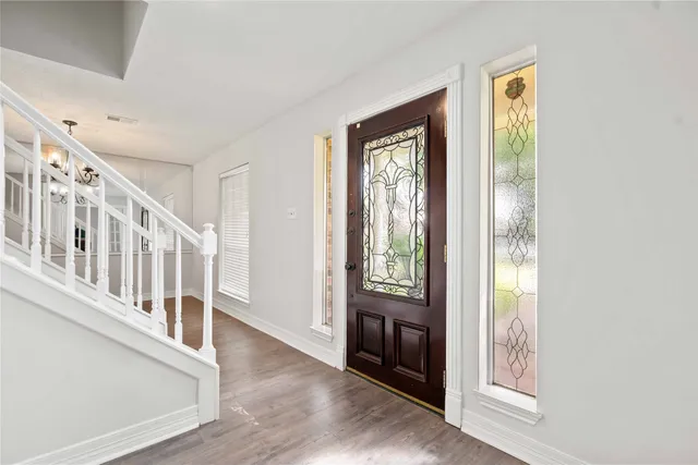a view of an entryway with wooden floor
