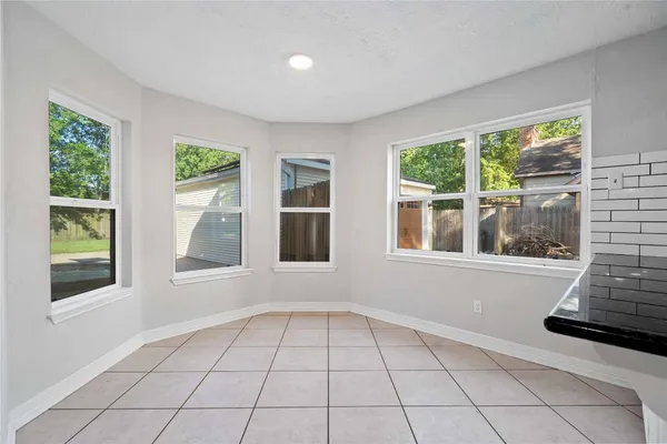 a kitchen with stainless steel appliances granite countertop a refrigerator a stove and a sink