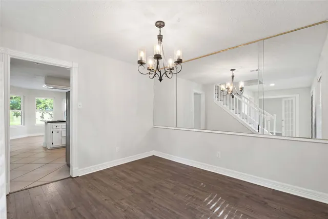 wooden floor in an empty room with a mirror