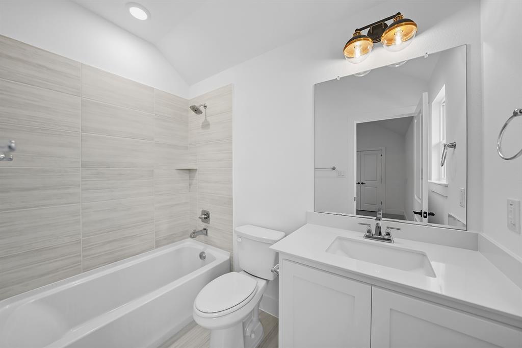 587 Mayfair Lane Frisco, TX 75033 - Photo 28 of 37 a bathroom with a sink a toilet and a bathtub