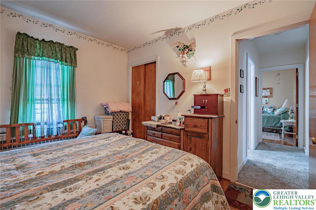 4250 Main Street Whitehall, PA 18052 - Photo 14 of 32 a bed room with a bed mirror and a window