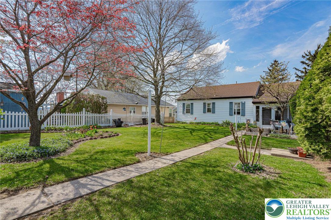 4250 Main Street Whitehall, PA 18052 - Photo 30 of 32 a view of a house with a yard and a large tree