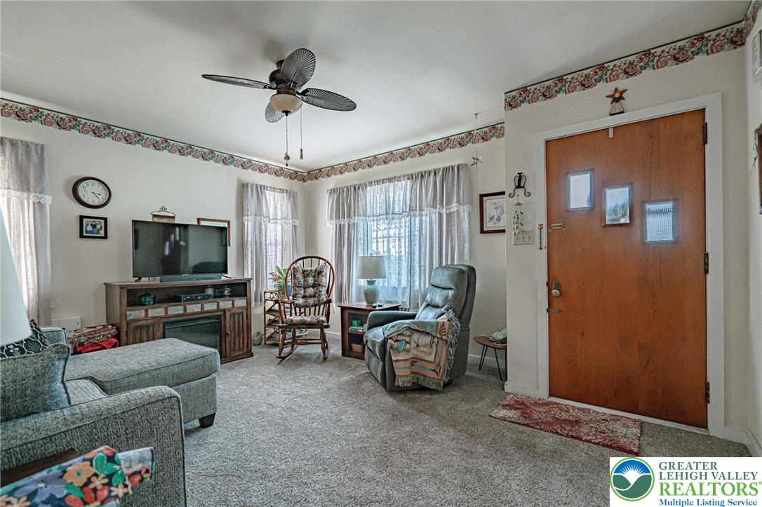 4250 Main Street Whitehall, PA 18052 - Photo 4 of 32 a living room with furniture a flat screen tv and a window