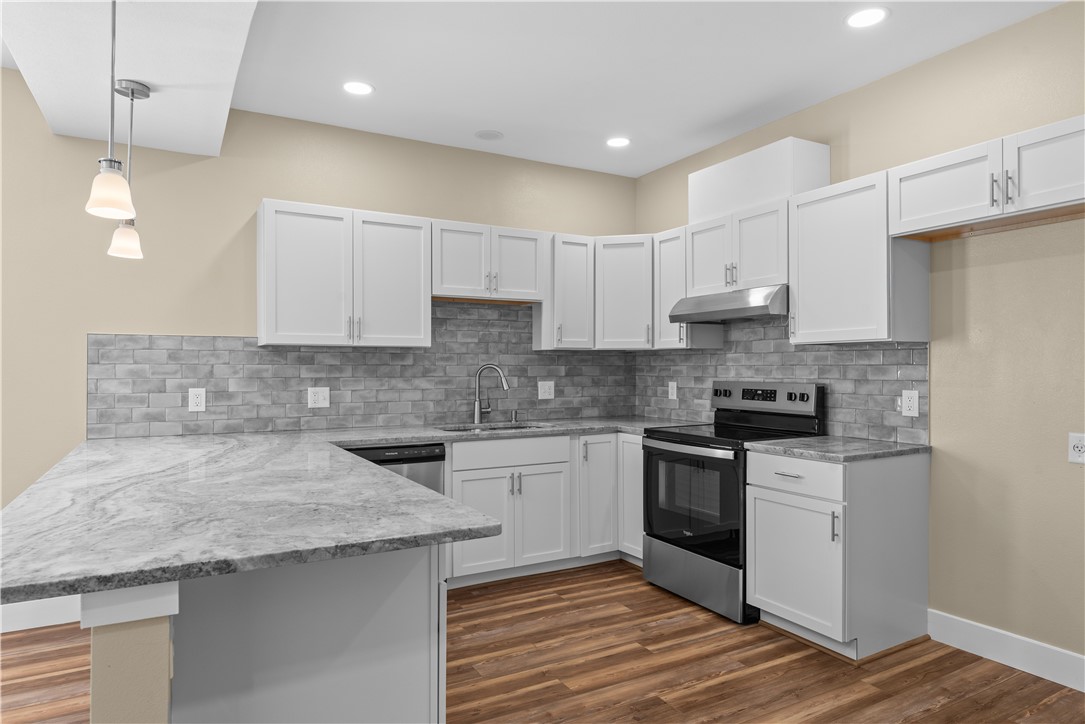 1017 12th Street Corpus Christi, TX 78404 - Photo 12 of 31 a kitchen with stainless steel appliances granite countertop a sink and cabinets