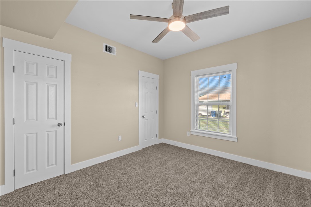 1017 12th Street Corpus Christi, TX 78404 - Photo 19 of 31 an empty room with windows and fan