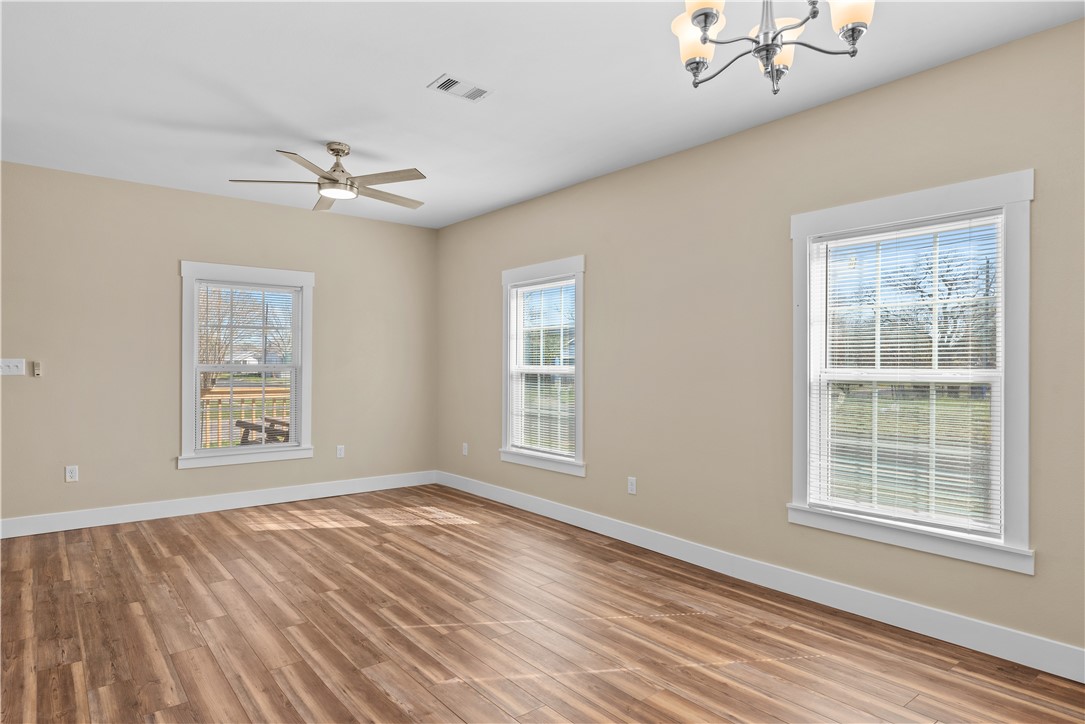 1017 12th Street Corpus Christi, TX 78404 - Photo 4 of 31 a view of an empty room with a window and wooden floor