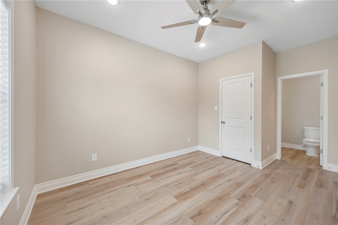 3213 Link Street, Unit 112 Bryan, TX 77801 - Photo 13 of 25 wooden floor in an empty room with a ceiling fan