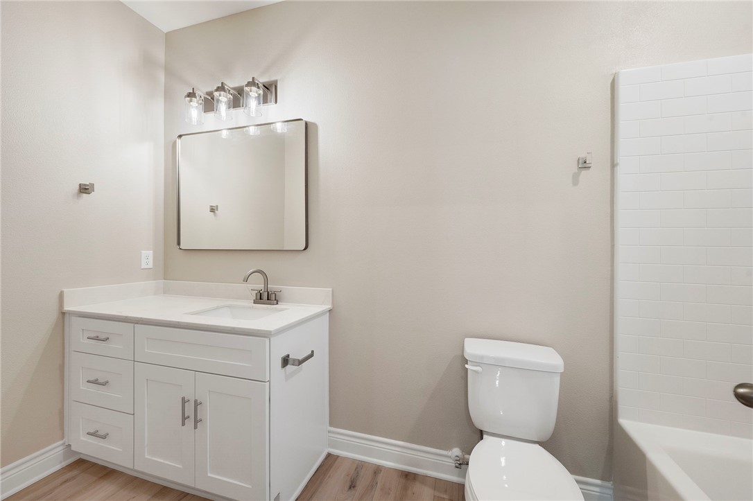 3213 Link Street, Unit 112 Bryan, TX 77801 - Photo 14 of 25 a bathroom with a toilet a sink and mirror
