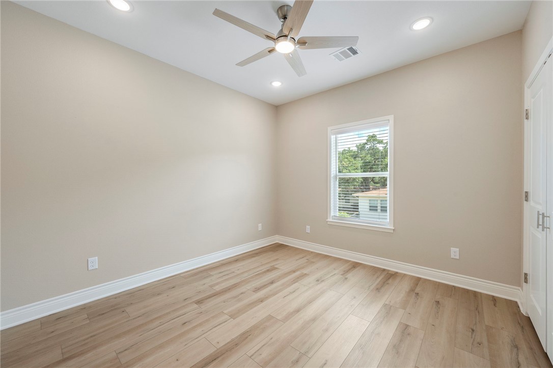 3213 Link Street, Unit 112 Bryan, TX 77801 - Photo 15 of 25 an empty room with wooden floor and windows