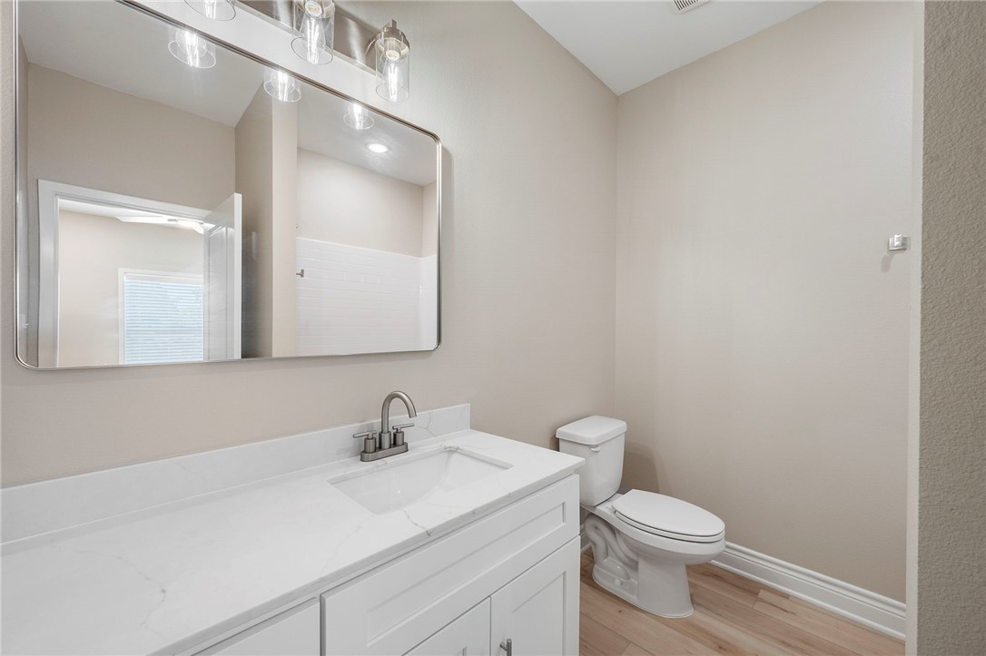 3213 Link Street, Unit 112 Bryan, TX 77801 - Photo 17 of 25 a bathroom with a toilet a sink and mirror
