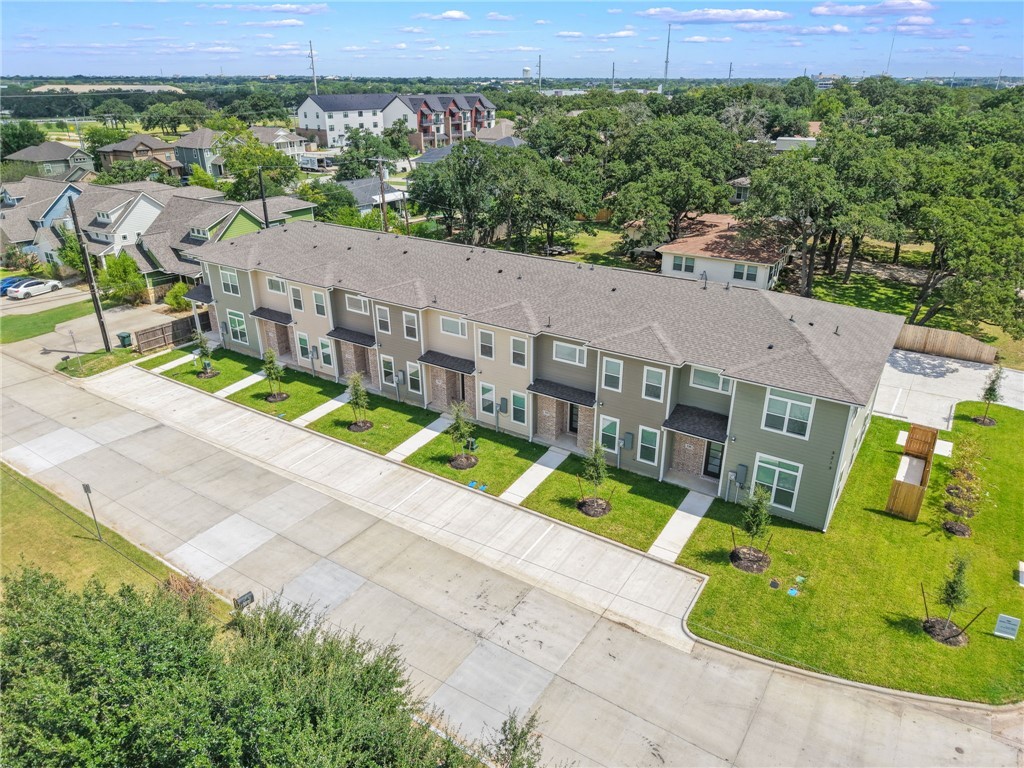 3213 Link Street, Unit 112 Bryan, TX 77801 - Photo 24 of 25 an aerial view of a house with a big yard and large trees