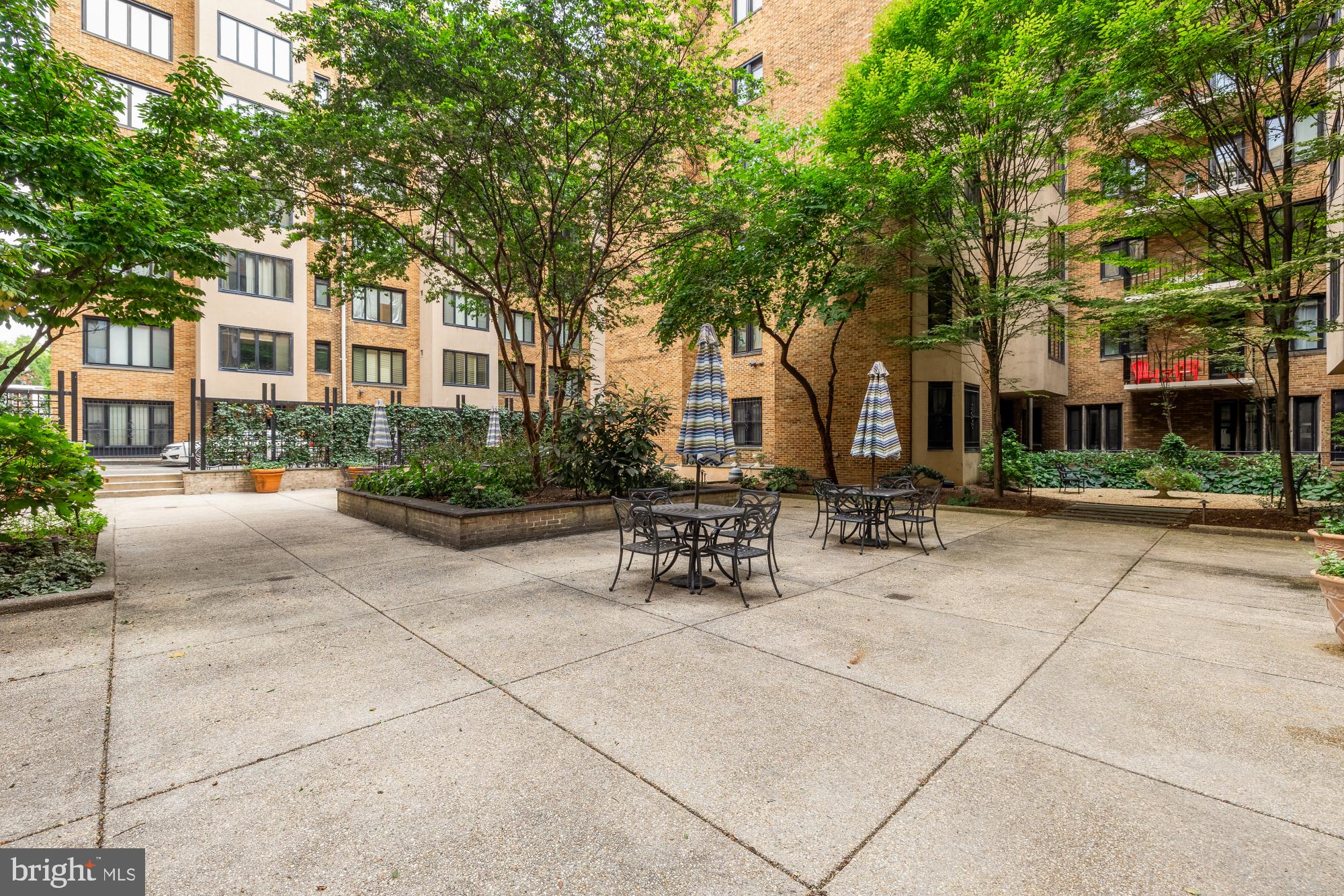 1701 16th Street Northwest, Unit 734 Washington, DC 20009 - Photo 29 of 30 a view of a building with a bench and trees