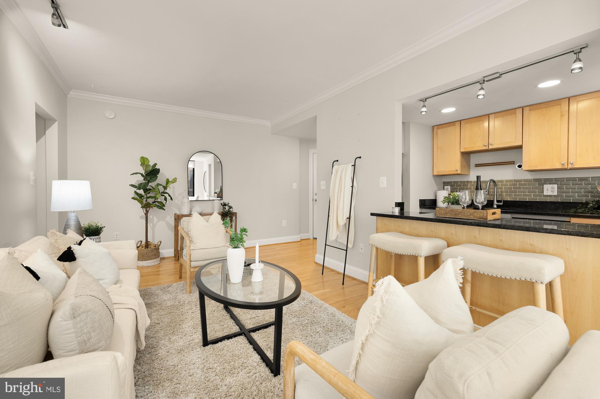 1701 16th Street Northwest, Unit 734 Washington, DC 20009 - Photo 6 of 30 a living room with furniture a large window and kitchen view
