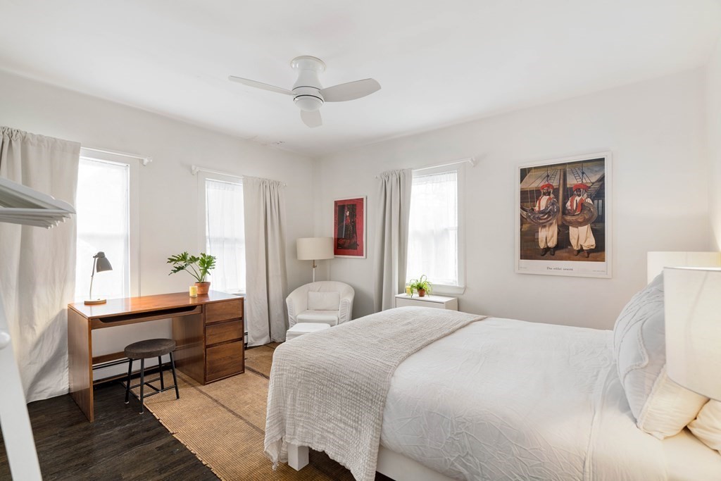 28 White Place Brookline, MA 02445 - Photo 13 of 18 a bedroom with a bed large window and furniture