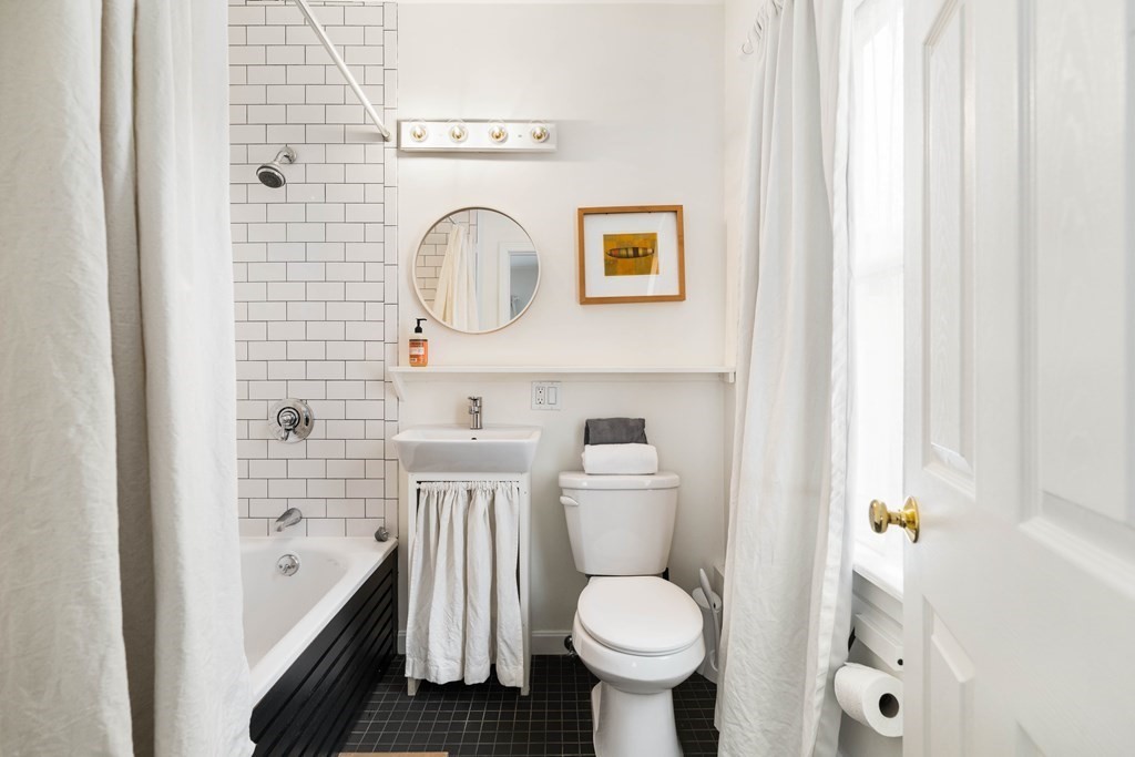 28 White Place Brookline, MA 02445 - Photo 14 of 18 a bathroom with a sink a toilet and shower curtain