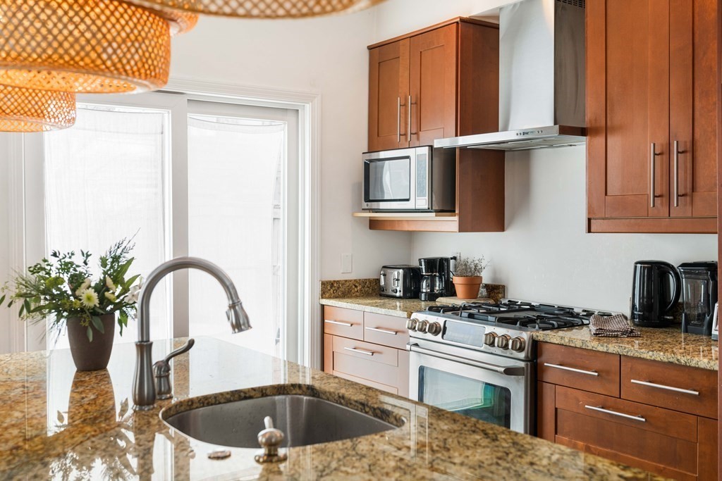 28 White Place Brookline, MA 02445 - Photo 5 of 18 a kitchen with granite countertop a stove a sink and a granite counter tops