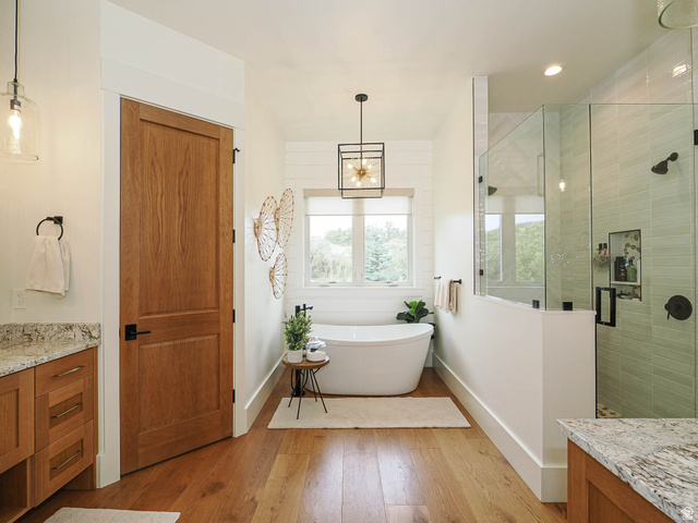 3167 South Mapleton Ests Drive Mapleton, UT 84664 - Photo 13 of 30 Freestanding soaking tub, walk-in shower with glass enclosure, wood-finish flooring, wood cabinetry with stone countertop, and custom light fixtures