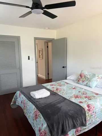 a bedroom with a bed and ceiling fan