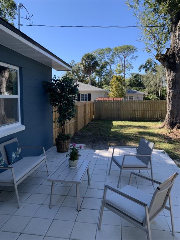 2237 Washington Road Mount Dora, FL 32757 - Photo 14 of 16 a backyard of a house with yard and outdoor seating