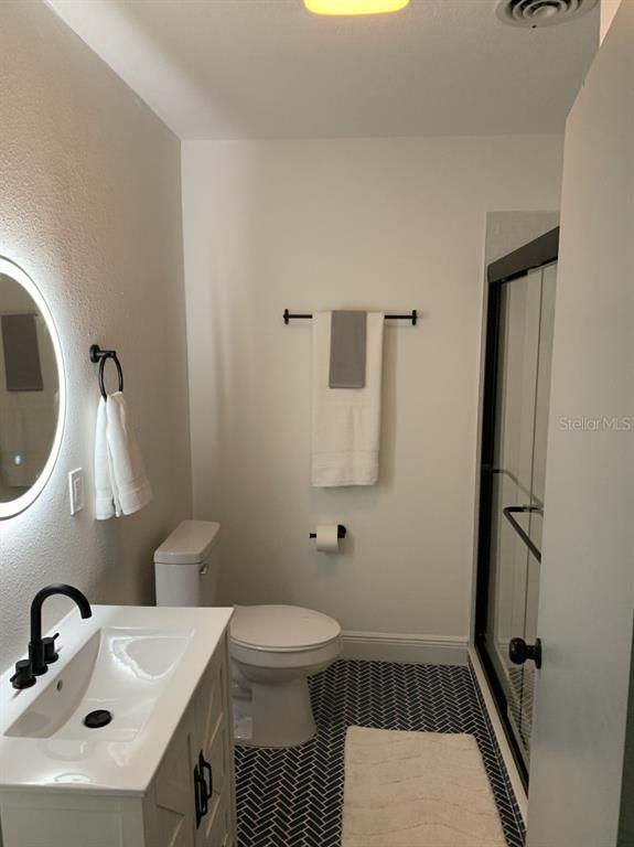 2237 Washington Road Mount Dora, FL 32757 - Photo 5 of 16 a bathroom with a sink toilet and shower