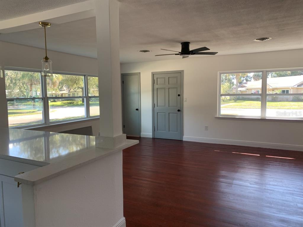 2237 Washington Road Mount Dora, FL 32757 - Photo 6 of 16 a view of an empty room with wooden floor and a window