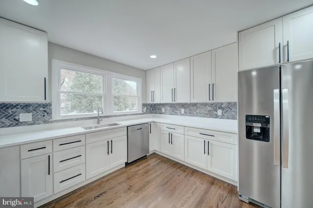 a kitchen with white cabinets and white appliances