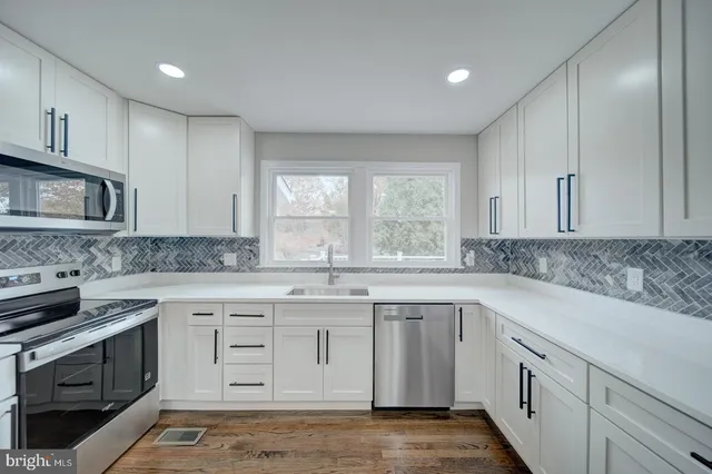 a kitchen with a sink stove and cabinets
