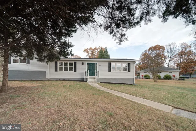 a house that has a tree in front of it