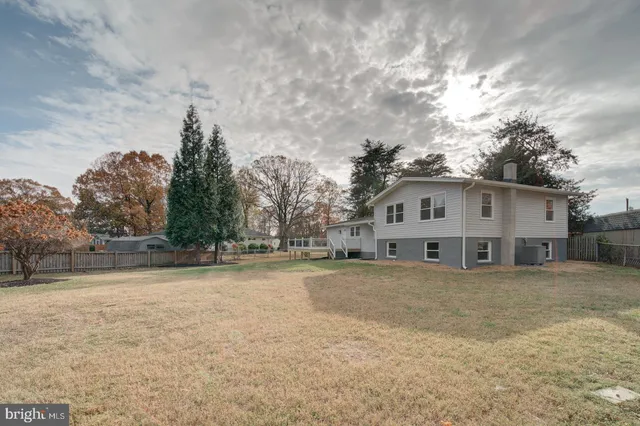 a view of a house with a yard covered in snow