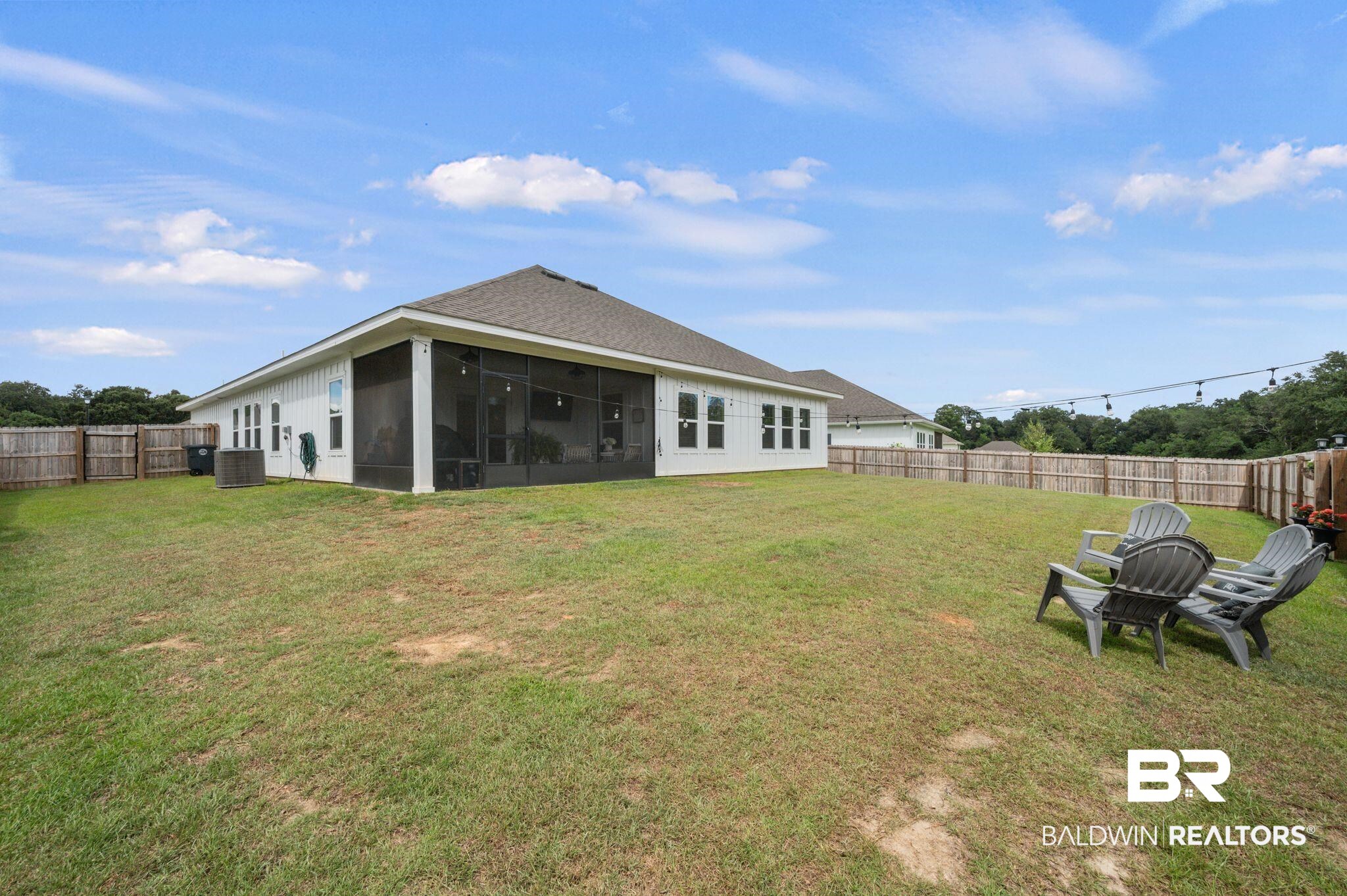 681 Calibre Street Fairhope, AL 36532 - Photo 51 of 56 Back of house featuring cooling unit, a yard, and a sunroom