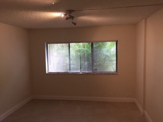 4216 Inverrary Boulevard, Unit 92A Lauderhill, FL 33319 - Photo 7 of 11 an empty room with a window