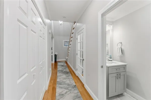 a view of a hallway with a white walls and stairs