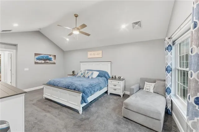 a bedroom with two beds and ceiling fan