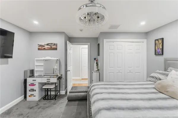 a spacious bedroom with a bed and furniture
