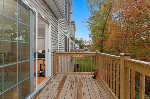 a view of balcony with wooden floor and fence and a pathway
