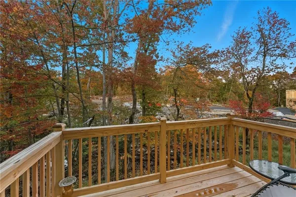 a view of a balcony with wooden fence and floor