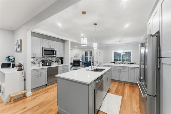 a kitchen with cabinets a sink and appliances